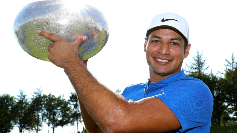 Julian Suri lifts the trophy after his four-shot success